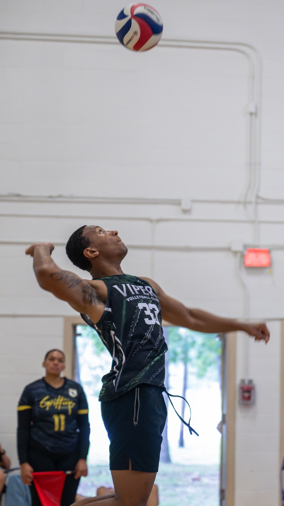 Player serving a volleyball.
