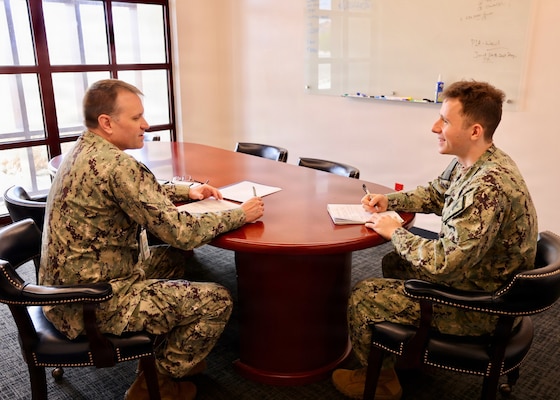 Lt. j.g. David J. Naiman (right), preventive medicine department head at Navy Medicine Readiness and Training Command (NMRTC) Twentynine Palms, meets one-on-one with Capt. Mark Miller, acting commanding officer, during the command’s “CO for a Day” program at Naval Hospital Twentynine Palms, California, July 21, 2026. The program provides junior officers firsthand exposure to command-level leadership, decision-making and responsibilities. (U.S. Navy photo by Christopher Jones, NMRTC/NH Twentynine Palms public affairs officer).