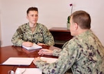 Lt. j.g. David J. Naiman (left), preventive medicine department head at Navy Medicine Readiness and Training Command (NMRTC) Twentynine Palms, meets one-on-one with Capt. Mark Miller, acting commanding officer, during the command’s “CO for a Day” program at Naval Hospital Twentynine Palms, California, July 21, 2026. The program provides junior officers firsthand exposure to command-level leadership, decision-making and responsibilities. (U.S. Navy photo by Christopher Jones, NMRTC/NH Twentynine Palms public affairs officer).