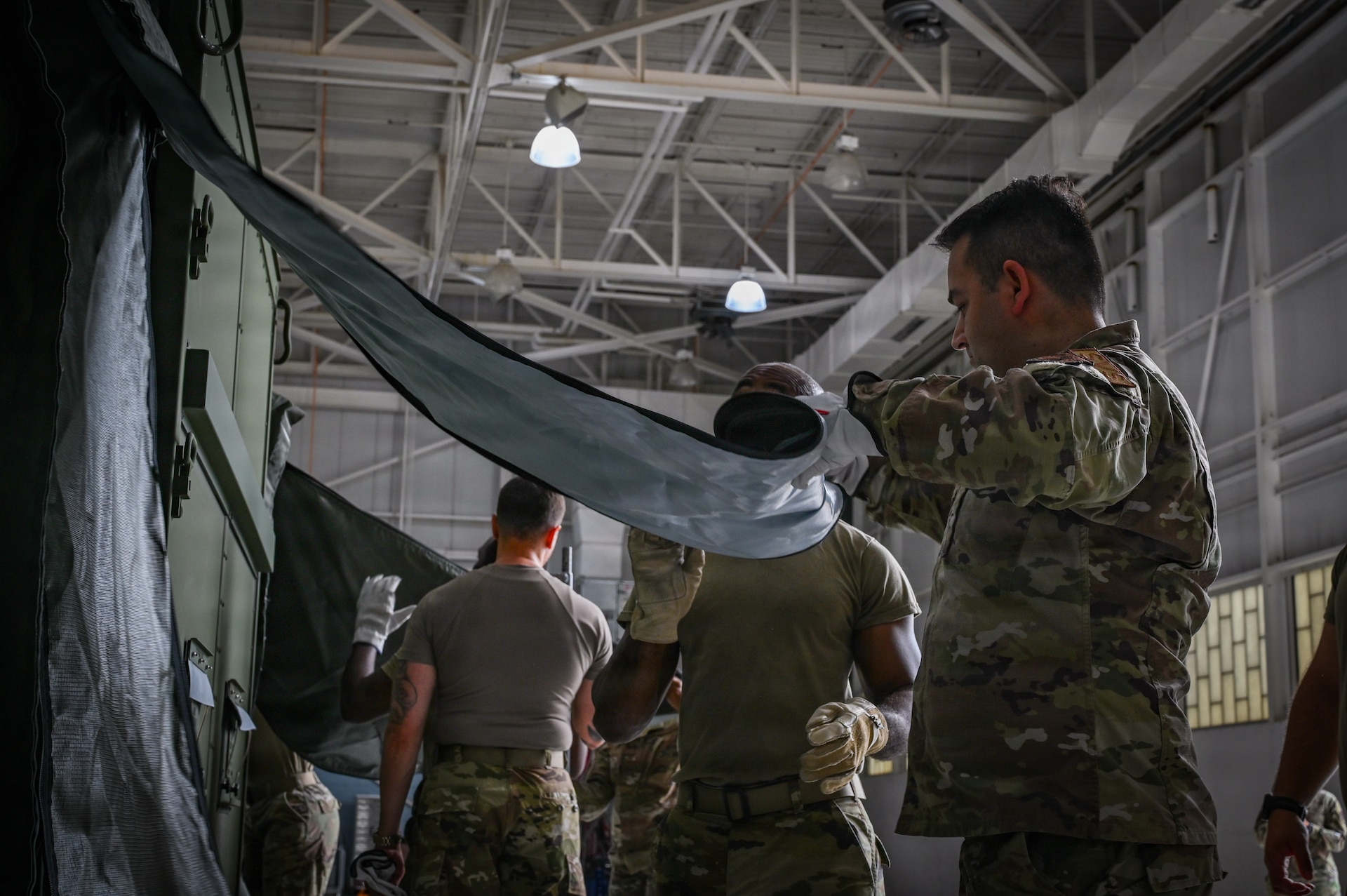 Pennsylvania and Texas Air National Guardsmen assigned to the 111th Attack Wing and the 149th Fighter Wing, work together to set up a Expandable Single Pallet Expeditionary Kitchen (E-SPEK) during a joint training at Biddle Air National Guard Base, Horsham, Pennsylvania, Aug. 17, 2026. The purpose of this training was to complete training required every 24 months, to ensure deployment readiness, and to work together with other wings. (Pennsylvania Air National Guard photo by Staff Sgt. Charles Casner)