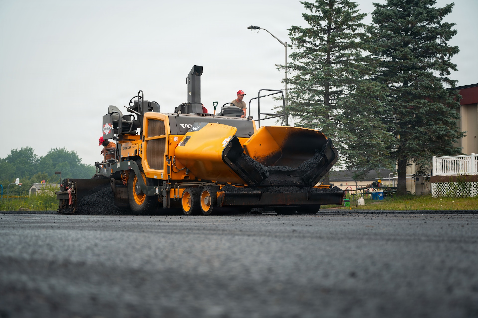 Airmen assigned to the 111th Attack Wing’s 201st RED HORSE Squadron, Detachment 1, operate an asphalt paver during the final stages of a paving project at Tobyhanna Army Depot, Pa., July 16, 2026. The project progressed from demolition and site preparation through base-course placement and asphalt paving, providing Airmen real-world experience applicable to future RED HORSE missions. (U.S. Air National Guard photo by Senior Airman Matthew Bergh)