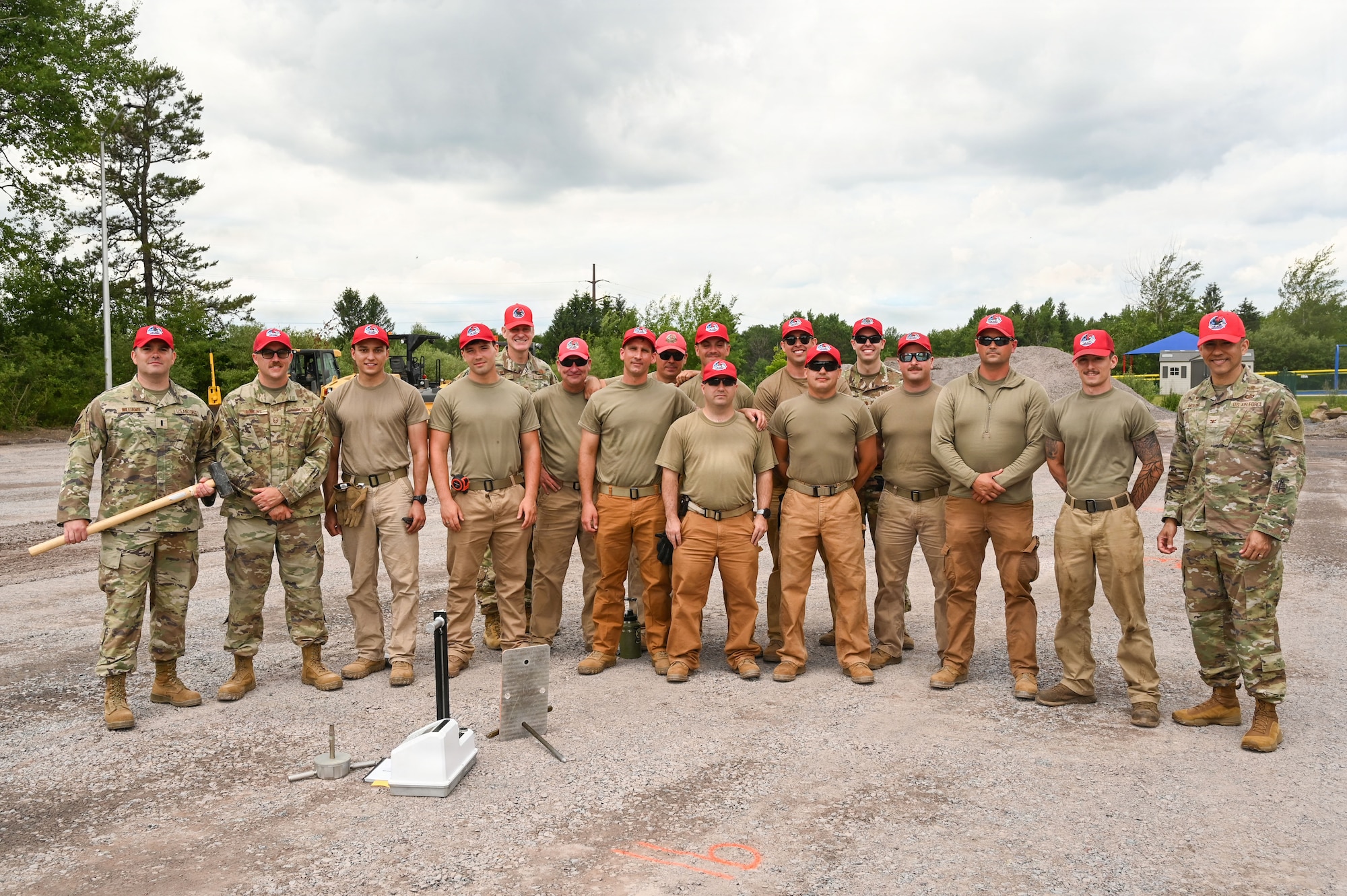 Airmen assigned to the 111th Attack Wing’s 201st RED HORSE Squadron, Detachment 1, pose for a group photo during a paving project at Tobyhanna Army Depot, Pa., June 17, 2026. The project provided a real-world training environment for RED HORSE Airmen to strengthen pavement construction skills while supporting infrastructure improvements at the depot. (U.S. Air National Guard photo by Senior Airman Matthew Bergh)
