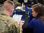 An EMAC coordinator and an Indiana National Guard representative work together during an exercise at the EMAC Coordinator and National Guard Workshop in Indianapolis Aug. 12-13. The workshop provided an opportunity for EMAC coordinators and National Guard representatives from across the country to build relationships and refine best practices in emergency response. Courtesy photo.