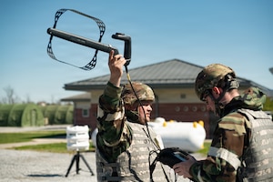 U.S. Air Force Tech. Sgt. Christopher Peluso, left, and Senior Airman Warren Planker, both assigned to the Pennsylvania Air National Guard’s 111th Attack Wing, 270th Engineering Installation Squadron, operate radio frequency direction-finding equipment during a combat readiness exercise at Fort Indiantown Gap, Pennsylvania, April 11, 2026. The Airmen used specialized equipment to analyze and locate RF signals while practicing techniques designed to support operations in a field environment. (U.S. Air National Guard photo by Senior Airman Matthew Bergh)