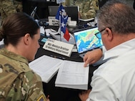 An EMAC coordinator and a Texas National Guard representative work together during an exercise at the EMAC Coordinator and National Guard Workshop in Indianapolis Aug. 12-13.