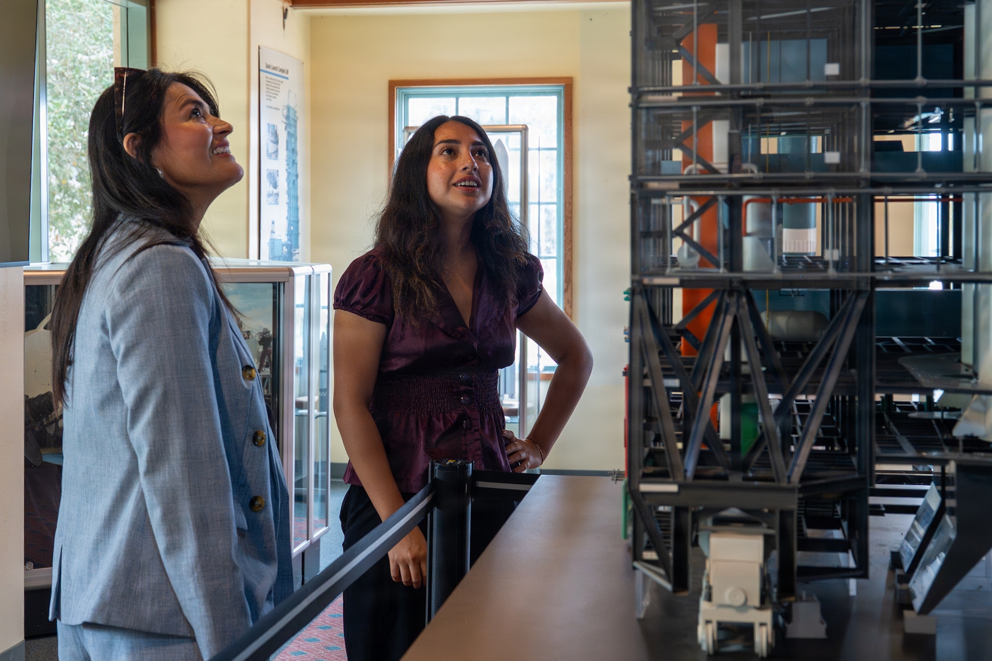Two people look at an object at a museum