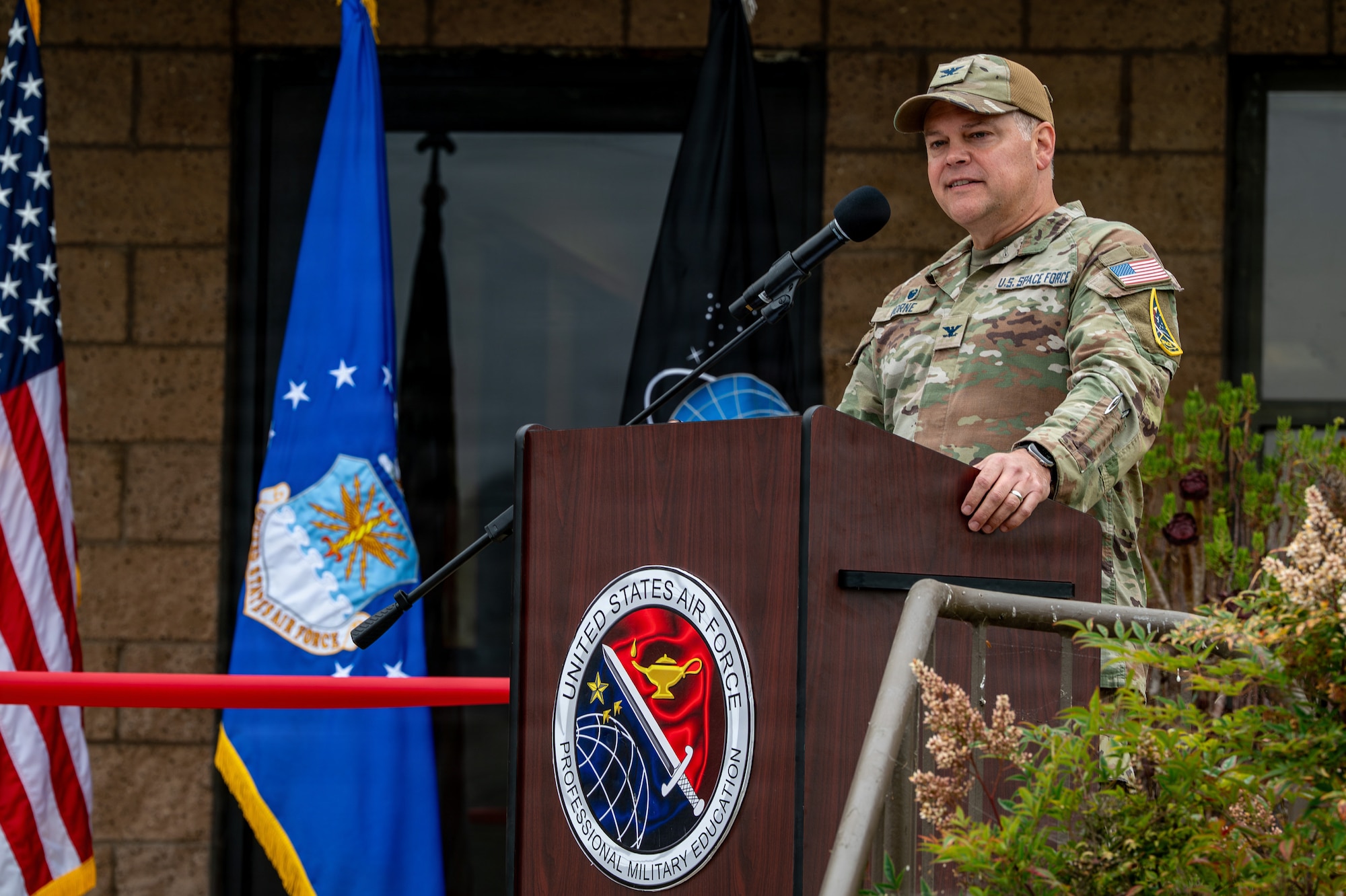 A person stands and speaks behind a podium