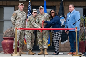 People stand and cut a ribbon