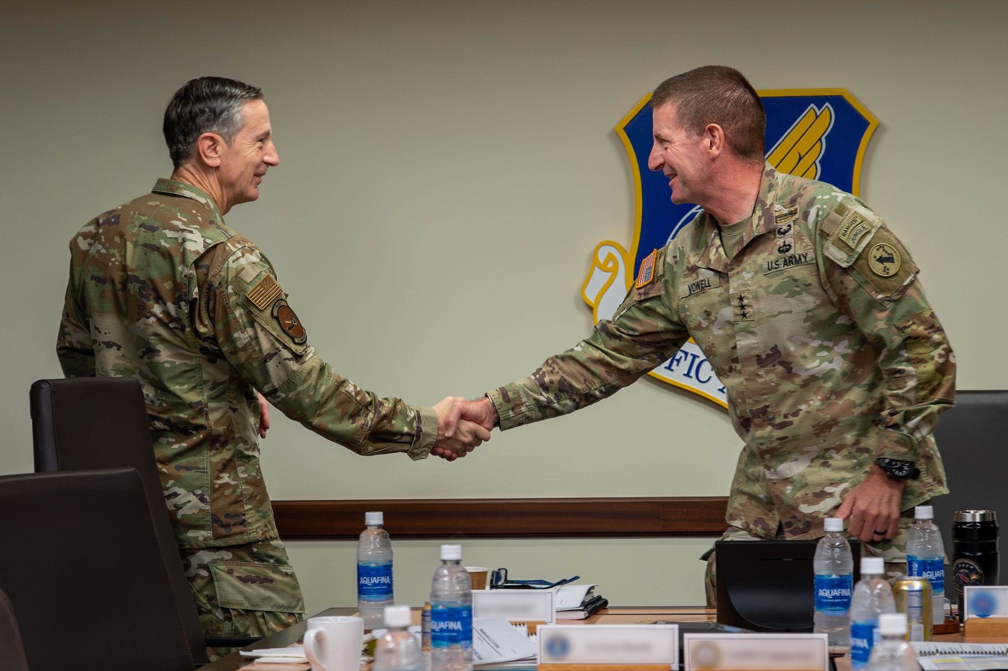 Two military officers shake hands