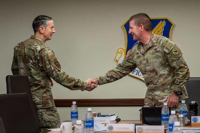 Two military officers shake hands