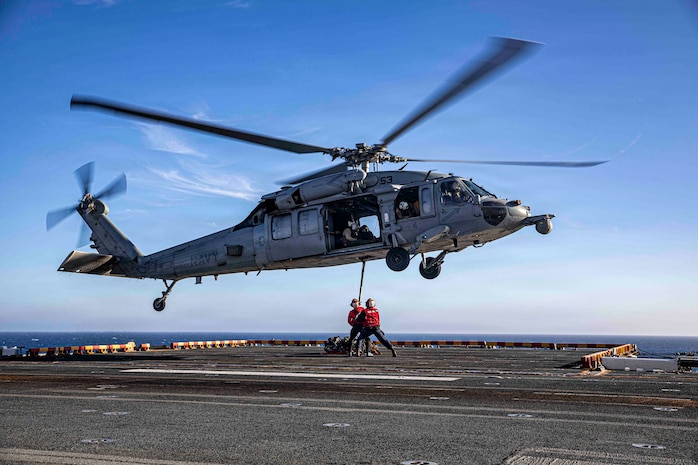 U.S. Navy Aviation Ordnancemen 3rd Class Kiomasa Kaminanga and U.S. Navy Aviation Ordnancemen 3rd Class Damien Heard, both assigned to Wasp-class amphibious assault ship USS Makin Island (LHD 8), conduct a vertical replenishment exercise with an MH-60S Sea Hawk, attached to Helicopter Sea Combat Squadron (HSC) 23, on the flight deck, August 18, 2026.
