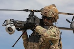 U.S. Army Staff Sgt. Stetson Manuel, an infantryman and Robotics and Autonomous Systems platoon sergeant from Alpha Company, 1st Battalion, 29th Infantry Regiment, 316th Cavalry Brigade, carries the Ghost-X Unmanned Aircraft System after its flight during experimentation at Project Convergence - Capstone 4, March 11, 2024 at Fort Irwin, Calif. This iteration of the U.S. Army-led experimentation included Soldiers from Fort Moore, Ga. and Fort Bragg (formerly Fort Liberty), N.C. (U.S. Army photo by Sgt. Charlie Duke)