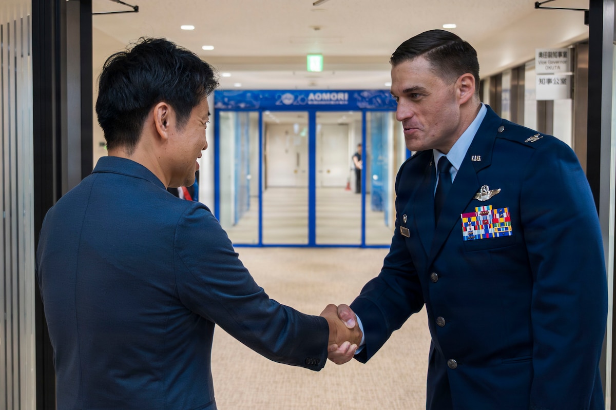 Aomori Prefecture Gov. Sōichirō Miyashita, left, and U.S. Air Force Col. Oliver Lause, 35th Fighter Wing commander, right, shakes hands following an introductory office call in Aomori City, Japan, Aug. 19, 2026.