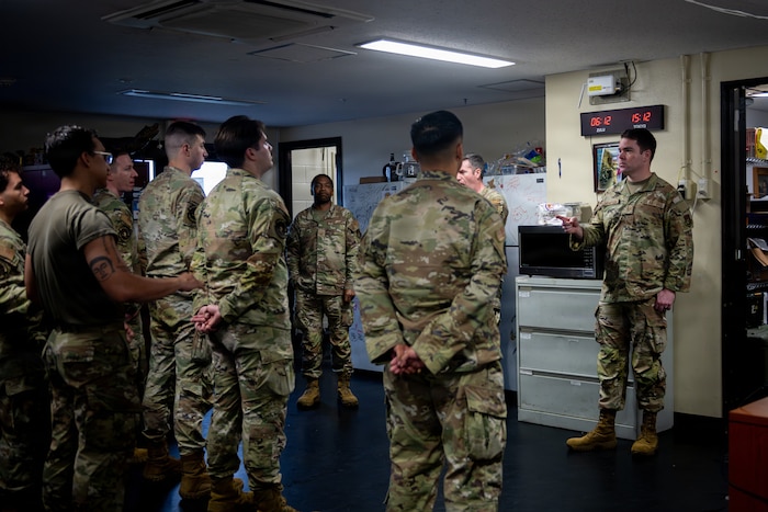 U.S. Air Force Tech. Sgt. Jeffrey Thompson, right, 35th Maintenance Squadron transient alert section chief, leads a turnover between day shift and swing shift.