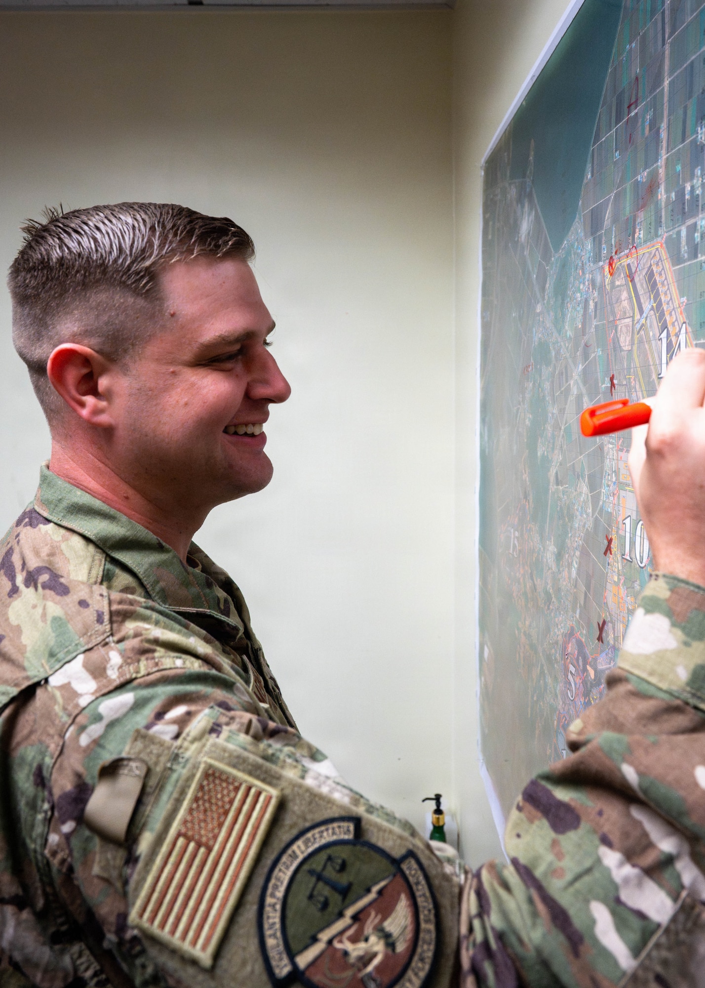 Airman writes on map.