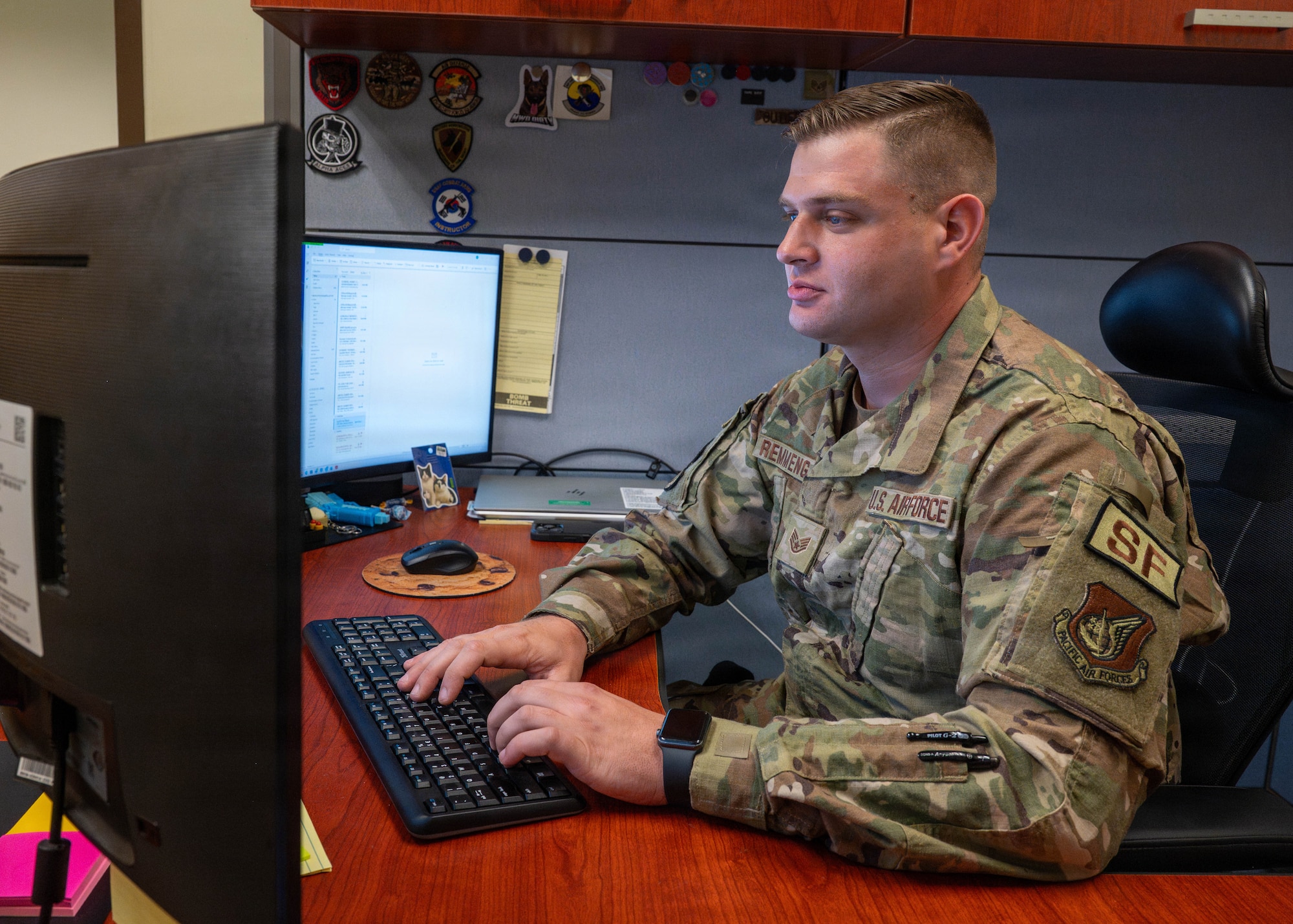 Airmen works at desk.