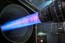 An Aircraft engine runs at full after burner in a test cell.