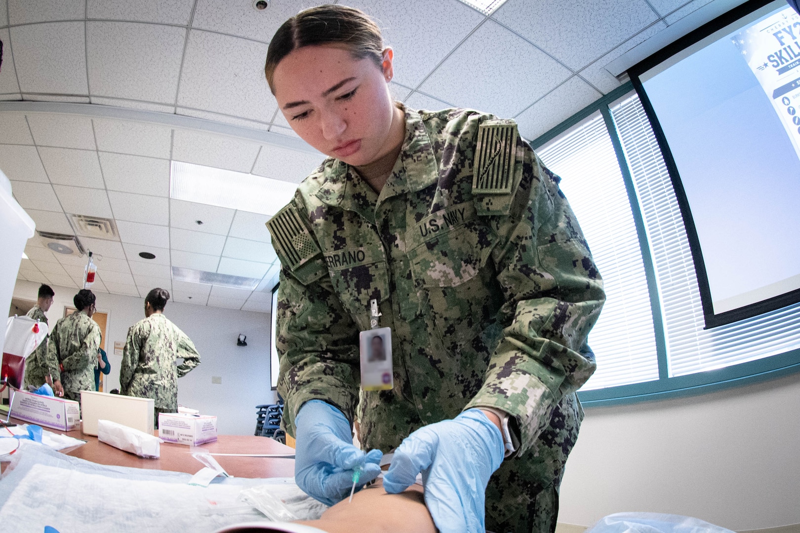*Training*  Hospitalman Alyssandra Serrano trains to insert an IV needle in a training aid during a skills fair conducted Thursday, August 20, 2026, at Navy Medicine Readiness and Training Command Cherry Point.  The Skills Fair evaluated the knowledge of corpsmen assigned to the facility and trained them on competencies and tasks expected of them in an operational environment.