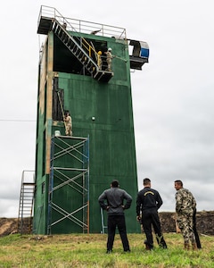 Members of the Massachusetts National Guard paint a sniper tower at the Escuela de Infantería (School of Infantry) in Remansito, Paraguay, July 23, 2026.