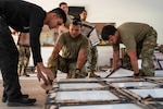 Members of the Massachusetts National Guard move floor tiles during construction and renovation work at Centro de Entrenamiento Conjunto de Operaciones de Paz (CECOPAZ), the Joint Peace Operations Training Center, in Asunción, Paraguay, July 16, 2026. Massachusetts National Guard engineers worked alongside Paraguayan military counterparts to upgrade facilities in preparation for Fuerzas Comando 2026, supporting the State Partnership Program between Massachusetts and Paraguay. Photo by Senior Airman Gadiel Concepcion Adorno.