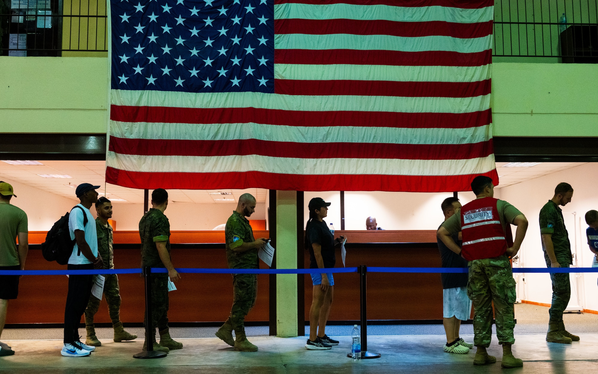 U.S. and Spanish personnel move through a patient processing area.