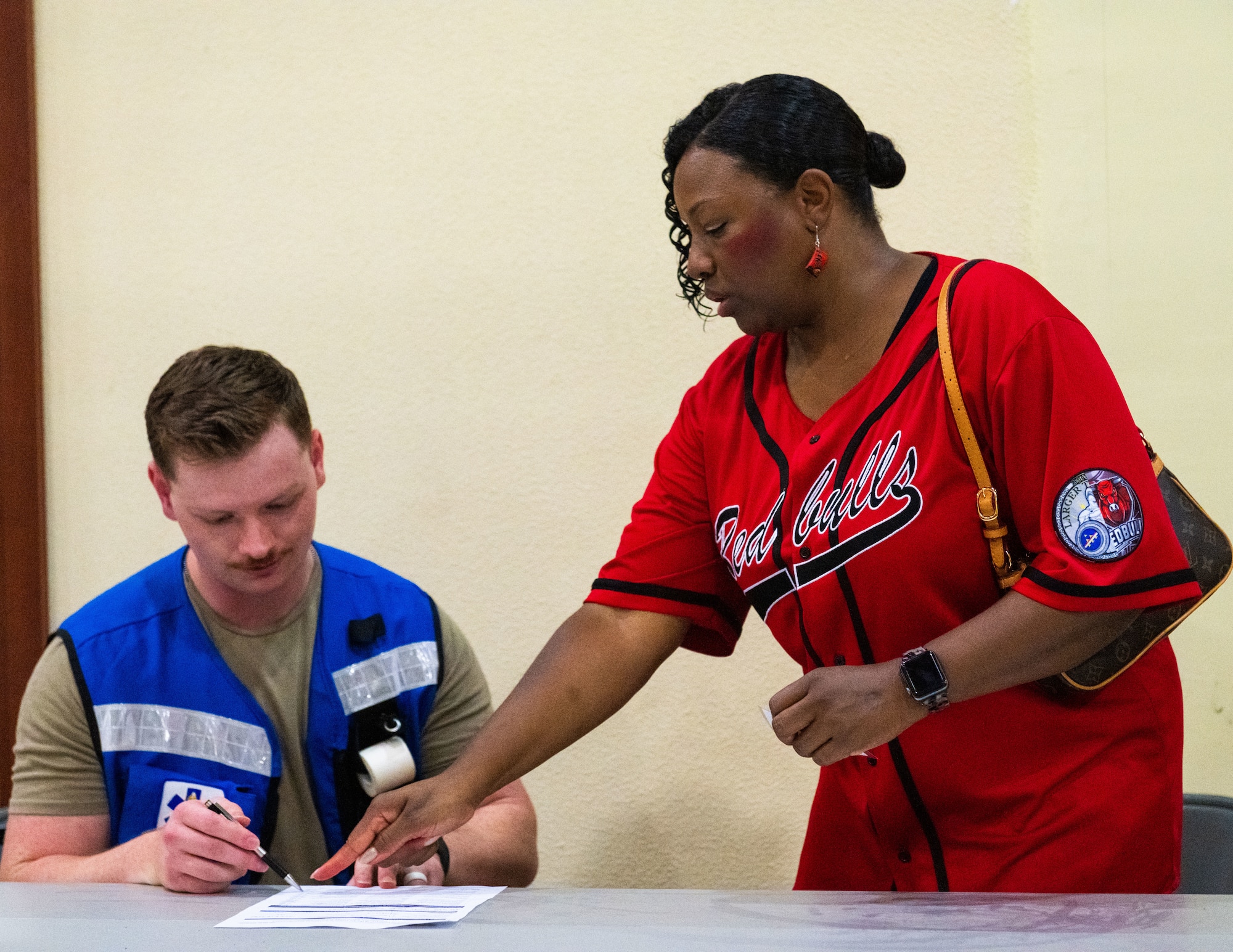 Shari Freeman, right, public health emergency exercise participant, provides information to a U.S. Airman assigned to the 39th Medical Group.