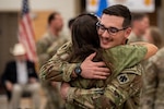 An Oklahoma Army National Guard Soldier assigned to the 745th Military Police Detachment, 345th Combat Sustainment Support Battalion, 90th Troop Command, Oklahoma Army National Guard, hugs a loved one during the unit’s welcome home ceremony in Mustang, Oklahoma, Aug. 20, 2026. The Citizen-Soldiers reunited with loved ones during a welcome home ceremony honoring the unit’s nine-month deployment to the U.S. Central Command area of responsibility. (Oklahoma National Guard photo by Anthony Jones)