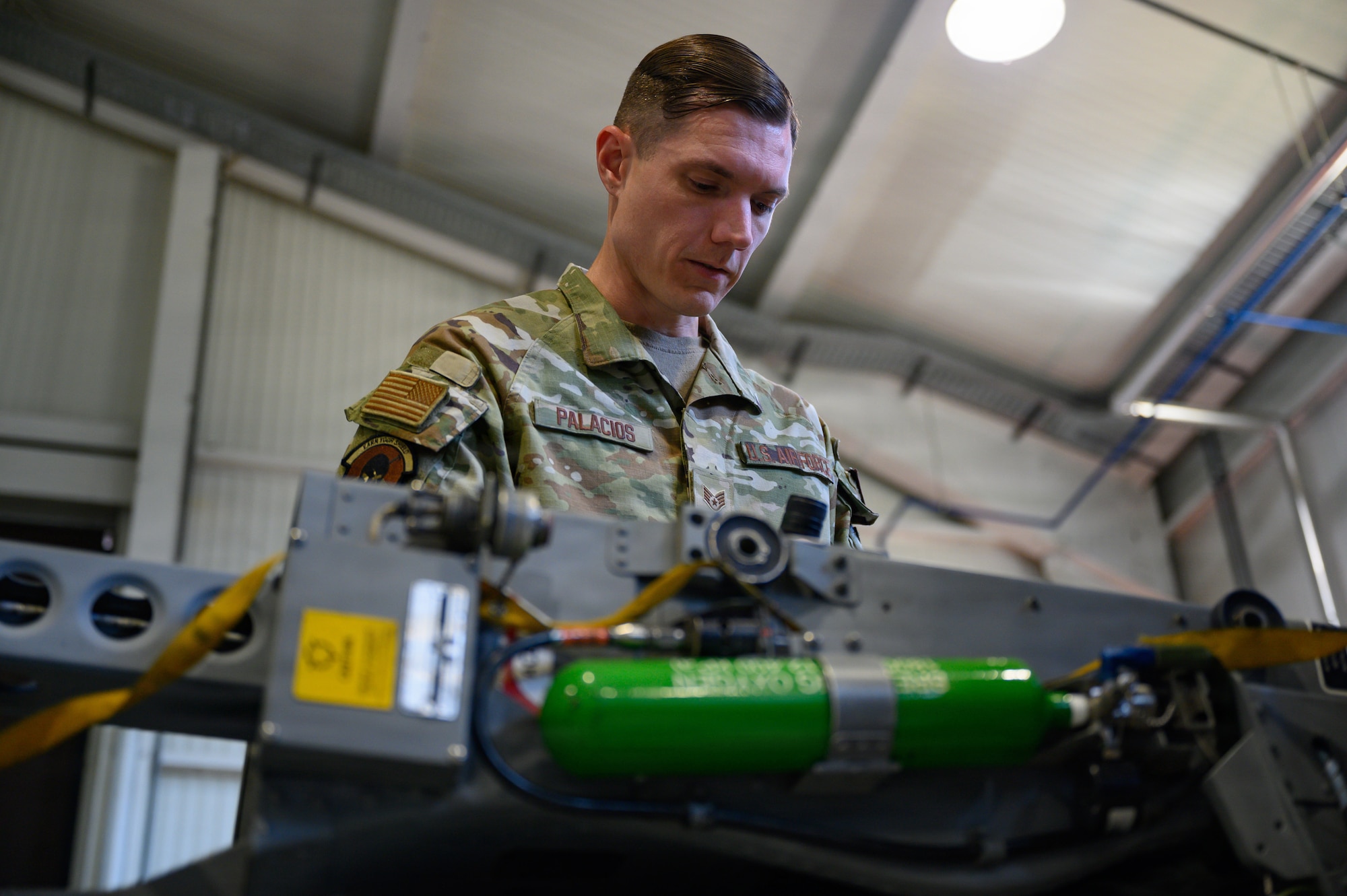 A person works on an ejection seat.