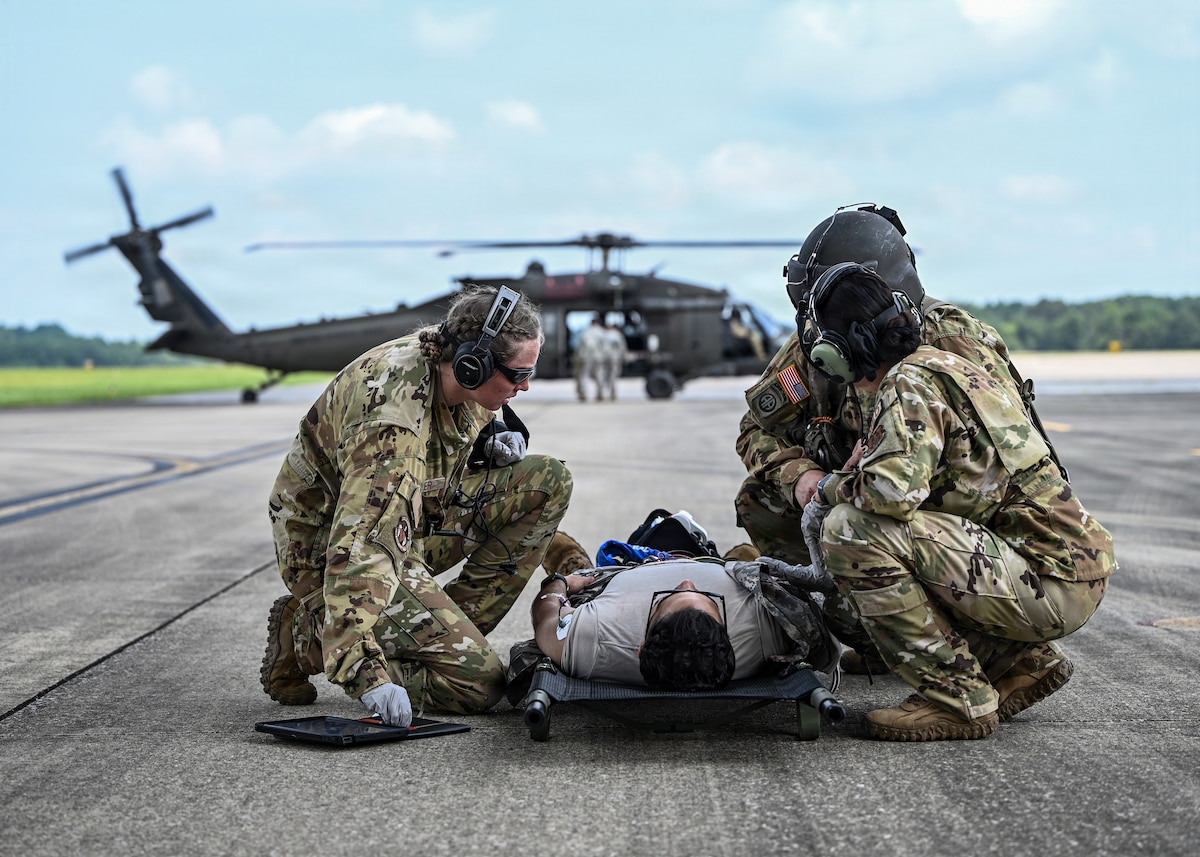 Staff Sgt. Amaya Hagler, a 445th Aeromedical Evacuation Squadron medical technician, checks the vital signs of a simulated patient portrayed by a U.S. Army Soldier assigned to Charlie Company, 5th Battalion, 159th General Support Aviation Battalion, during tactical aeromedical evacuation and joint-service patient transfer training at Fort Knox, Ky., July 29, 2026. The training integrated mock patient transport and in-flight care aboard an Army UH-60 Black Hawk and an Air Force C-17 Globemaster III, enabling patient transition from tactical care to long-range aeromedical evacuation. (U.S. Air Force photo by Patrick O’Reilly)