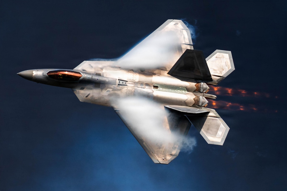 An F-22 Raptor assigned to the F-22 Raptor Demonstration Team flies past pyrotechnic smoke during the Arctic Thunder Open House at Joint Base Elmendorf-Richardson, Alaska, Aug. 8, 2026. The F-22 is the Air Force’s premier fifth-generation fighter, combining stealth, supercruise and advanced sensor capabilities. (U.S. Air Force photo by Airman 1st Class Theodore Gowdy)
