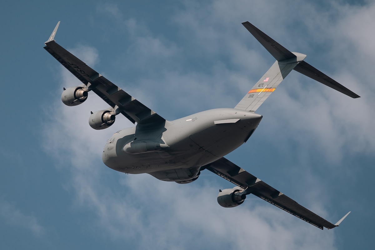 A C-17 Globemaster III flies over Altus Air Force Base, Okla., Aug. 13, 2026. The C-17 provides rapid strategic airlift of troops and cargo while supporting tactical airlift, aeromedical evacuation and airdrop missions worldwide. (U.S. Air Force photo by Senior Airman Jonah Bliss)