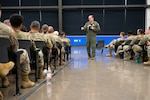 Col. Douglas C. Jeffrey IV, 433rd Airlift Wing commander, speaks to an audience of personnel assigned to the wing during an all call at Joint Base San Antonio- Lackland, Texas, Aug. 1, 2026. During his final address to the wing, he praised the exceptional work witnessed during his tenure at the “Alamo Wing,” mission updates, and a heartfelt goodbye. (U.S. Air Force photo by Tech. Sergeant Ashley Tsoi)