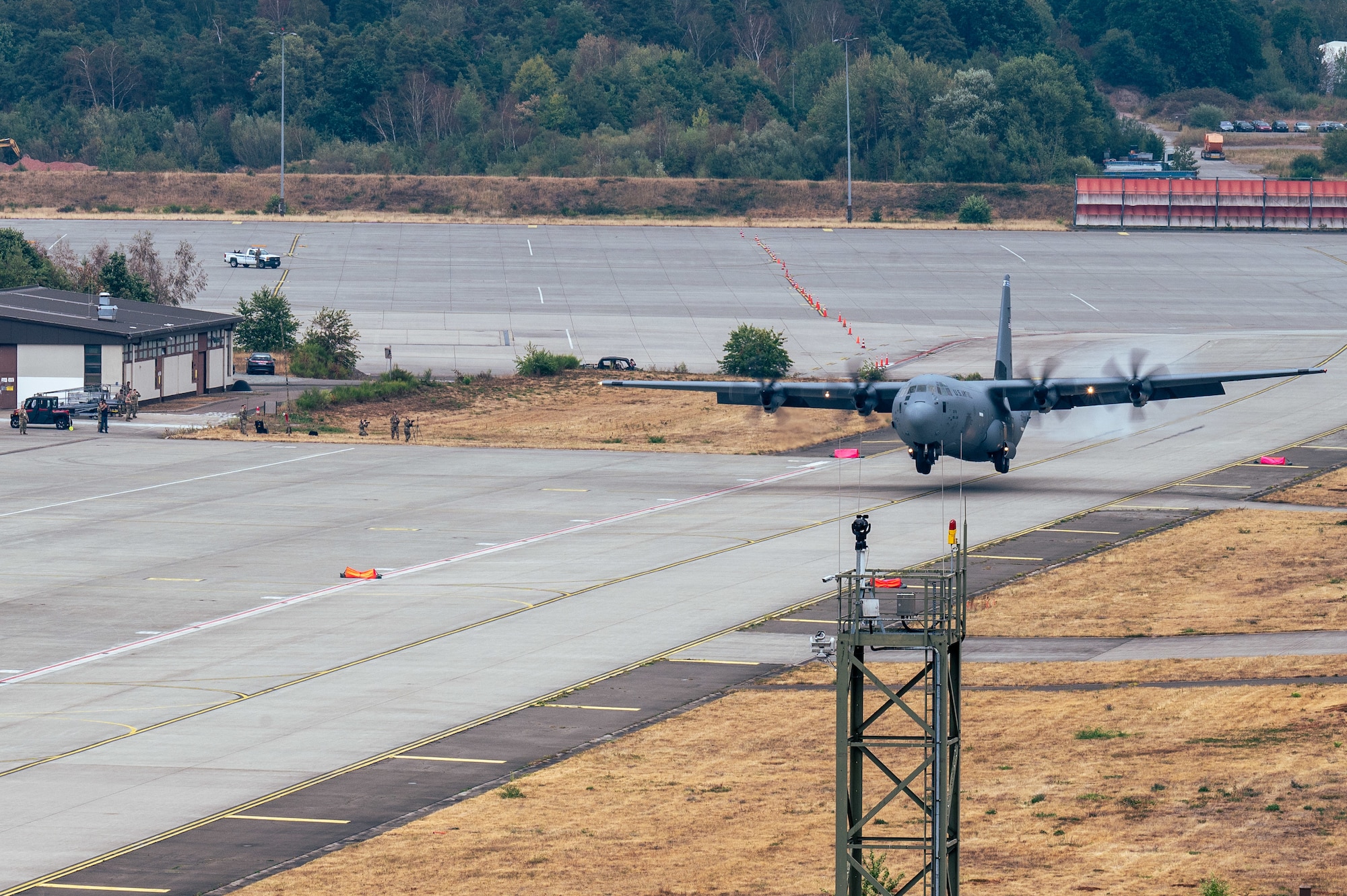 A C-130J Super Hercules aircraft lands on a taxiway at Ramstein Air Base, Germany, Aug. 18, 2026. The training ensured airfield personnel maintain the proficiency required to execute precision landings on short, narrow and unmarked strips of land. (U.S. Air Force photo by Airman 1st Class Joseph Curzi)