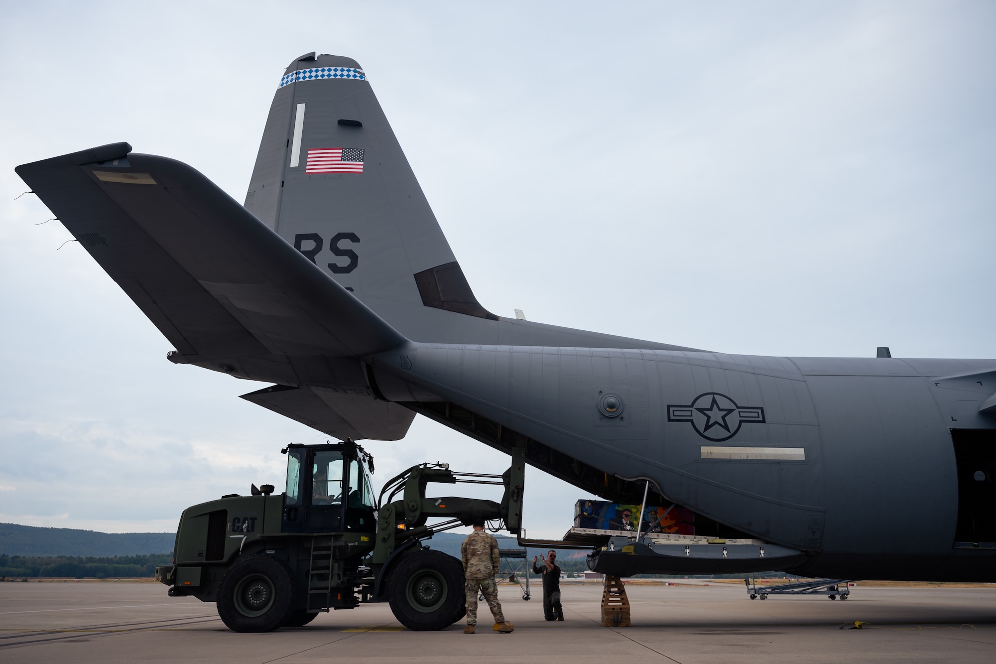 U.S. Air Force Airmen assigned to the 37th Airlift Squadron and 721st Aerial Port Squadron load cargo onto a C-130J Super Hercules aircraft at Ramstein Air Base, Germany, Aug. 18, 2026. Coordination between aircrew and aerial port specialists helps ensure personnel, equipment and aircraft are prepared to safely execute tactical airlift operations. (U.S. Air Force photo by Senior Airman Edgar Grimaldo)