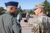 Gen. Gregory Guillot, commander of North American Aerospace Defense Command (NORAD) and U.S. Northern Command (USNORTHCOM), speaks with Gen. Adrian Spain, commander of Air Combat Command, outside of the NORAD and USNORTHCOM headquarters on Peterson Space Force Base, Colorado, Aug. 18, 2026. The commanders met to begin the annual Warfighter Talks, an executive-level engagement focused on synchronizing force presentation, modernizing command and control systems, and enhancing combined readiness to defend North America. (Dept. of War photo by U.S. Air Force Staff Sgt. Colten Tessness)