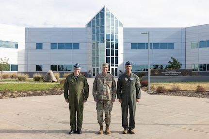 Gen. Gregory Guillot, center, commander of the North American Aerospace Defense Command (NORAD) and U.S. Northern Command (USNORTHCOM), Royal Canadian Air Force Lt. Gen. Iain Huddleston, deputy commander of NORAD, and U.S. Air Force Gen. Adrian Spain, commander of Air Combat Command, pose for a photo at NORAD and USNORTHCOM headquarters on Peterson Space Force Base, Colorado, Aug. 18, 2026. The commanders met to begin the annual Warfighter Talks, an executive-level engagement focused on synchronizing force presentation, modernizing command and control systems, and enhancing combined readiness to defend North America. (Dept. of War photo by U.S. Air Force Staff Sgt. Colten Tessness)
