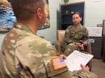 A mental health provider talks with a patient in a clinical office setting.