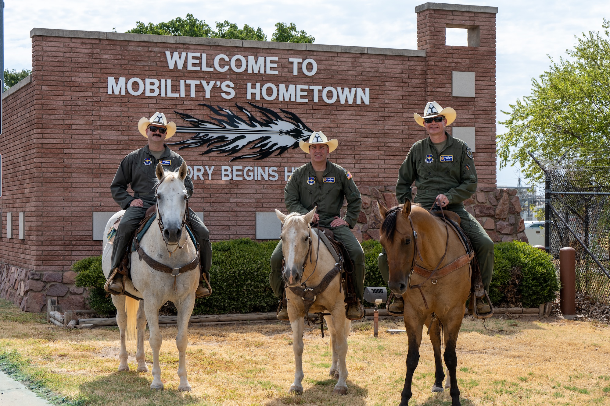 Col. Richard Kind, 97th Air Mobility Wing commander, right, Col. Joshua Moores, 97th AMW deputy commander, center, and Chief Master Sgt. Jonny Adams, 97th AMW command chief, pose for a photo during the annual Cattle Drive at Altus Air Force Base, Oklahoma, Aug. 20, 2026. The annual tradition celebrates the installation’s connection with the city of Altus and the local community. (U.S. Air Force photo by Airman 1st Class Nathan Langston)