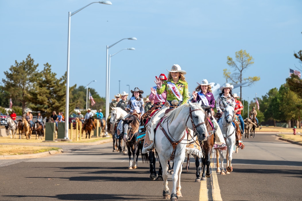 Teen rodeo royalty from Altus, Oklahoma lead the 28th Annual Cattle Drive at Altus Air Force Base, Oklahoma, Aug. 20, 2026. The Cattle Drive occurs on opening day of the local rodeo to bring the base and community together over their shared legacy. (U.S. Air Force photo by Senior Airman Kari Degraffenreed)