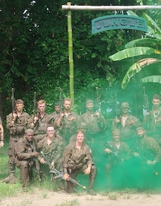 Soldiers pose for a group photo under the Jungle Operations Training sign in Panama June 17.