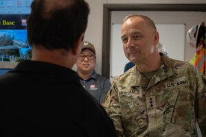 U.S. Army Lt. Gen. William H. “Butch” Graham Jr., 56th Chief of Engineers and U.S. Army Corps of Engineers commanding general, speaks with a USACE representative at Dyess Air Force Base, Texas, Aug. 18, 2026. The visit allowed Graham to meet with Dyess personnel to review facility requirements, construction timelines and infrastructure integration supporting the B-21 Raider beddown. (U.S. Air Force photo by Airman 1st Class William Neal)