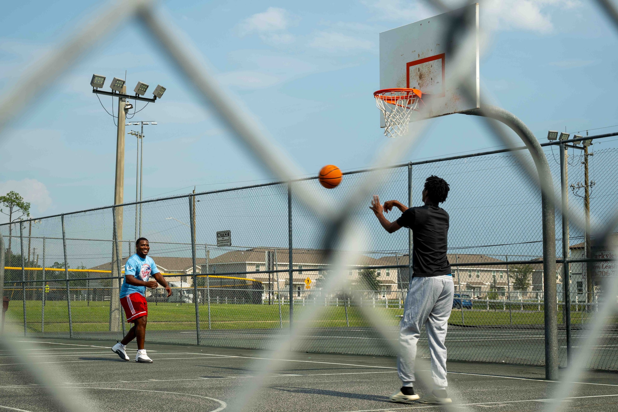 U.S. Air Force Senior Airman Vicen’te Thompkins, 337th Air Control Squadron weapons simulation technician, and his mentee, JT, play basketball in Panama City, Florida, July 29, 2026.