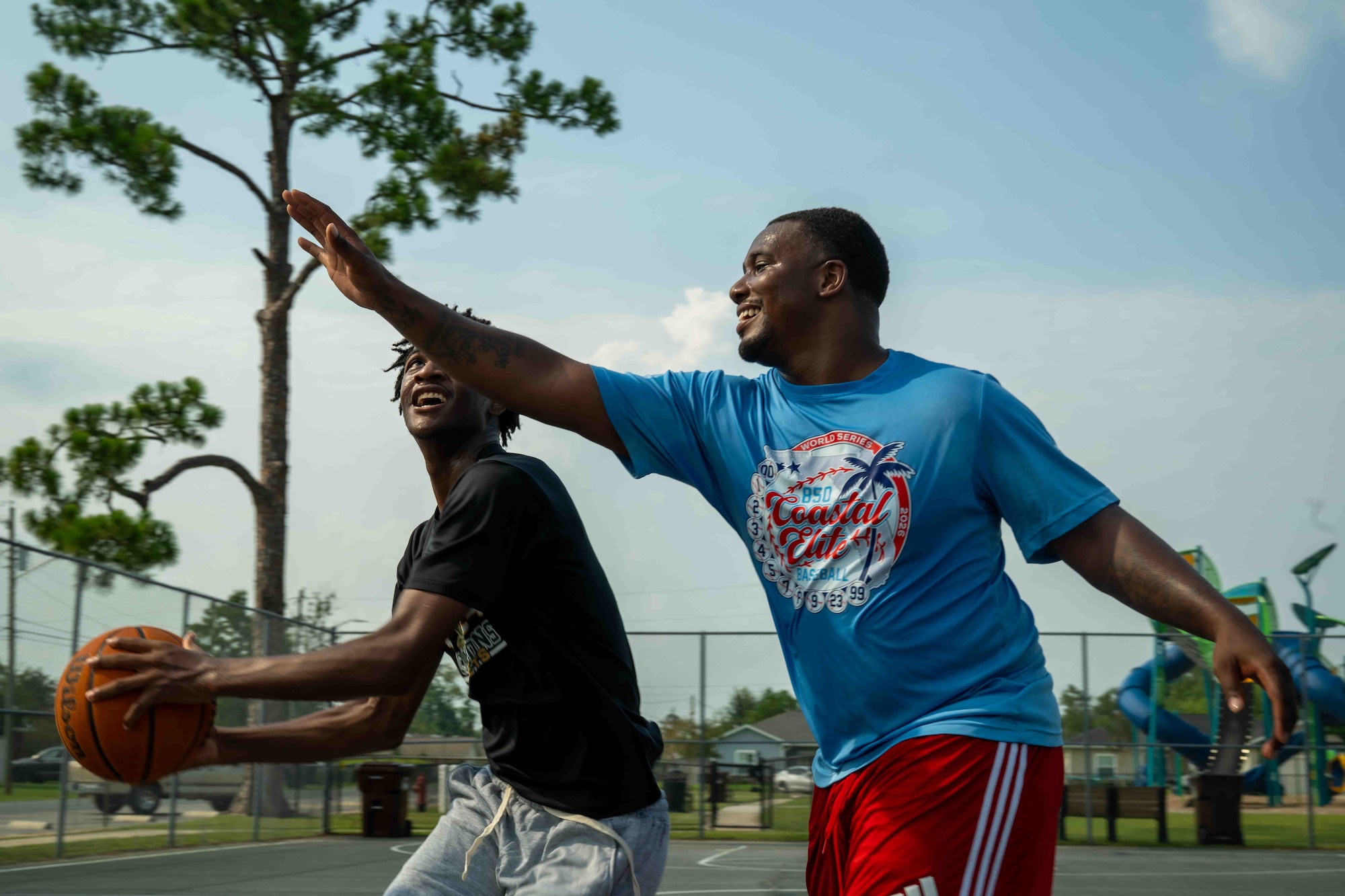 U.S. Air Force Senior Airman Vicen’te Thompkins, 337th Air Control Squadron weapons simulation technician, plays basketball with his mentee, JT in Panama City, Florida, July 29, 2026.