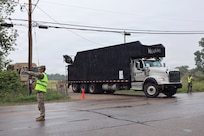 U.S. Soldiers assigned to the Wisconsin Army National Guard’s 1157th Transportation Company facilitate vehicle access to a natural debris collection site near Menasha, Wis., Aug. 5, 2026.