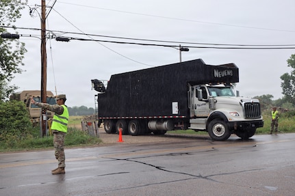 U.S. Soldiers assigned to the Wisconsin Army National Guard’s 1157th Transportation Company facilitate vehicle access to a natural debris collection site near Menasha, Wis., Aug. 5, 2026.