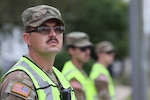 U.S. Army Sgt. Andrew Foley, a motor transport operator with the Wisconsin Army National Guard’s 1157th Transportation Company, restricts vehicle access to residential streets undergoing utility repairs in Menasha, Wis., July 31. Foley was one of 85 Wisconsin Soldiers placed on state active duty to assist Winnebago County civil authorities following severe storm damage in the region as part of Task Force Sturgeon. Photo by Paul Gorman.