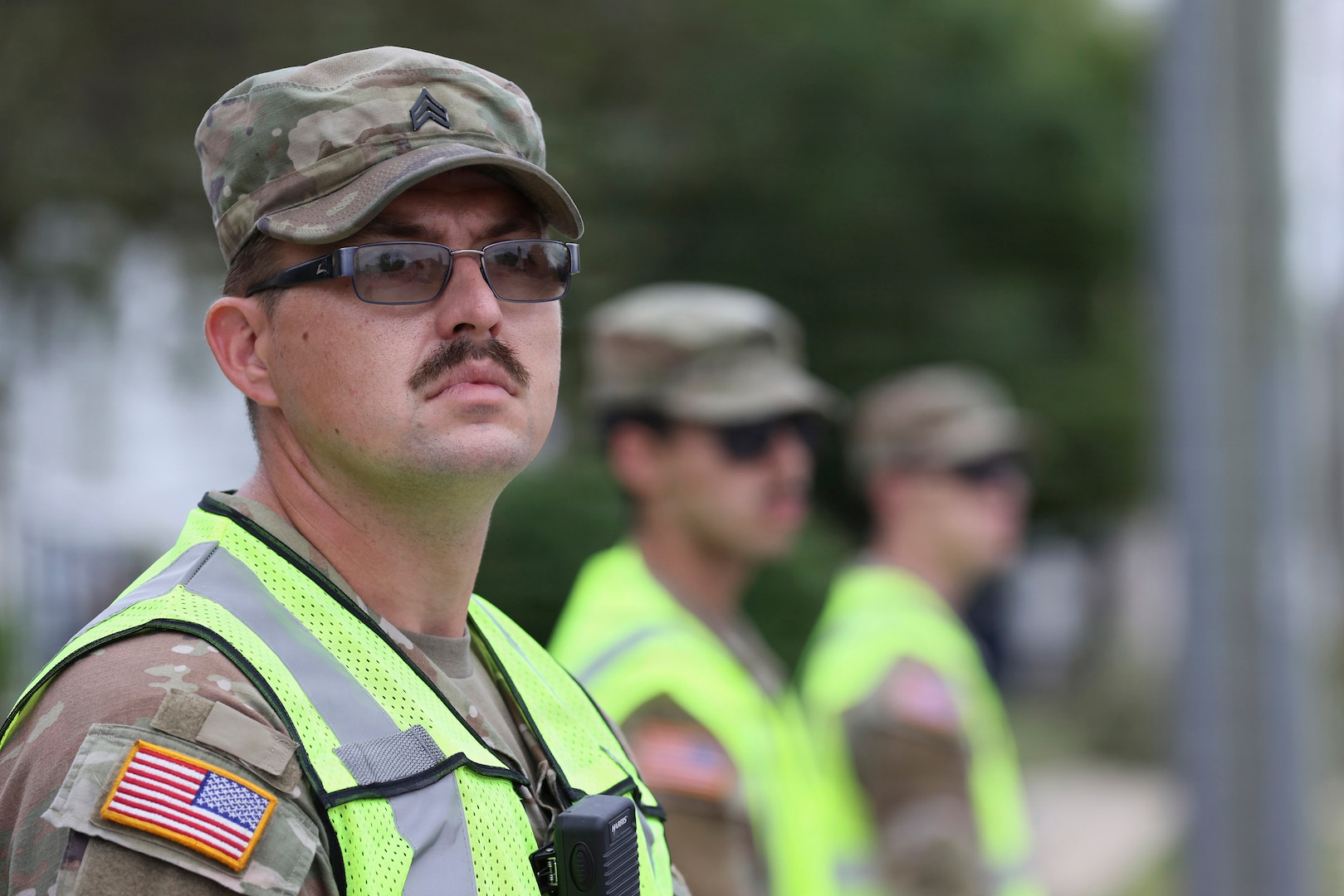 U.S. Army Sgt. Andrew Foley, a motor transport operator with the Wisconsin Army National Guard’s 1157th Transportation Company, restricts vehicle access to residential streets undergoing utility repairs in Menasha, Wis., July 31.