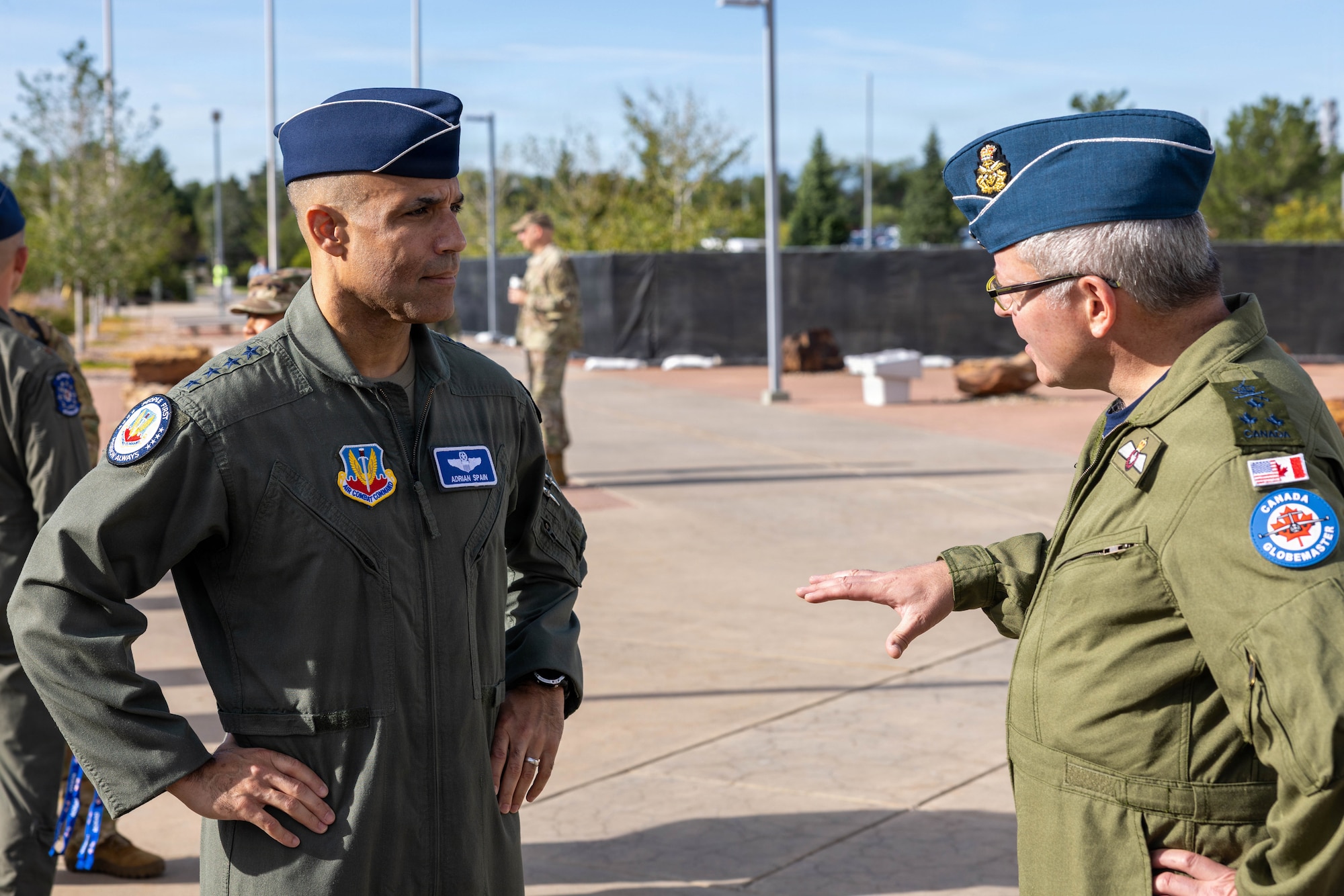 U.S. Air Force Gen. Adrian Spain, commander of Air Combat Command, left, speaks with Royal Canadian Air Force Lt. Gen. Iain Huddleston, deputy commander of North American Aerospace Defense Command (NORAD), outside of the NORAD and U.S. Northern Command (USNORTHCOM) headquarters on Peterson Space Force Base, Colorado, Aug. 18, 2026. The commanders met to begin the annual Warfighter Talks, an executive-level engagement between NORAD and USNORTHCOM, and ACC, focused on synchronizing force presentation, modernizing command and control systems, and enhancing combined readiness to defend North America. (Dept. of War photo by U.S. Air Force Staff Sgt. Colten Tessness)