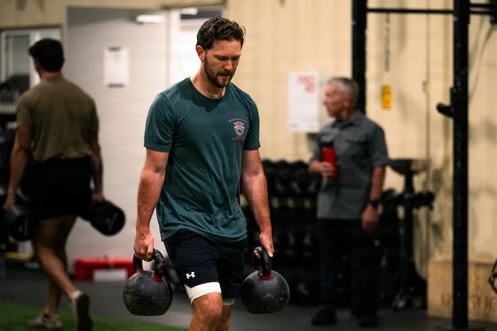 Person carrying dumbbells