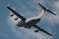 A C-17 Globemaster III flies over Altus Air Force Base, Okla., Aug. 13, 2026. The C-17 provides rapid strategic airlift of troops and cargo while supporting tactical airlift, aeromedical evacuation and airdrop missions worldwide. (U.S. Air Force photo by Senior Airman Jonah Bliss)